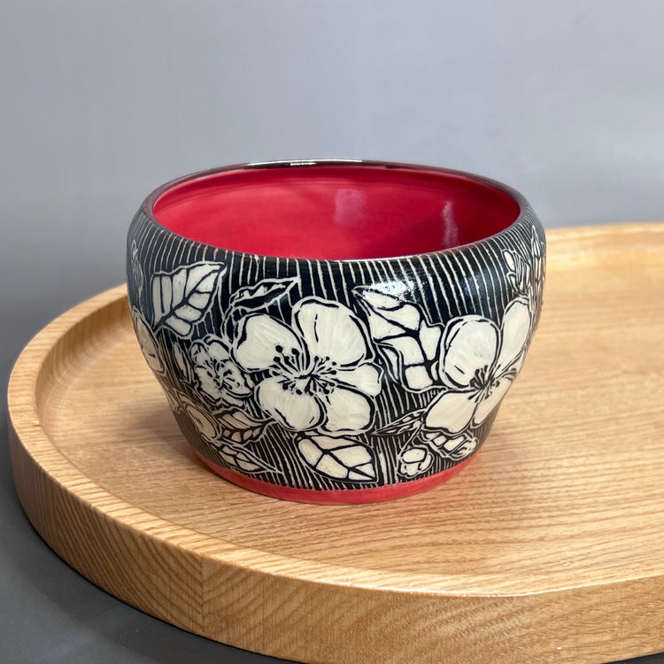 Mushroom and ferns are drawn in white by carving  into the black glaze. 